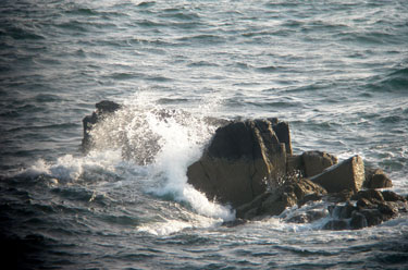 Waves crashing over a rock